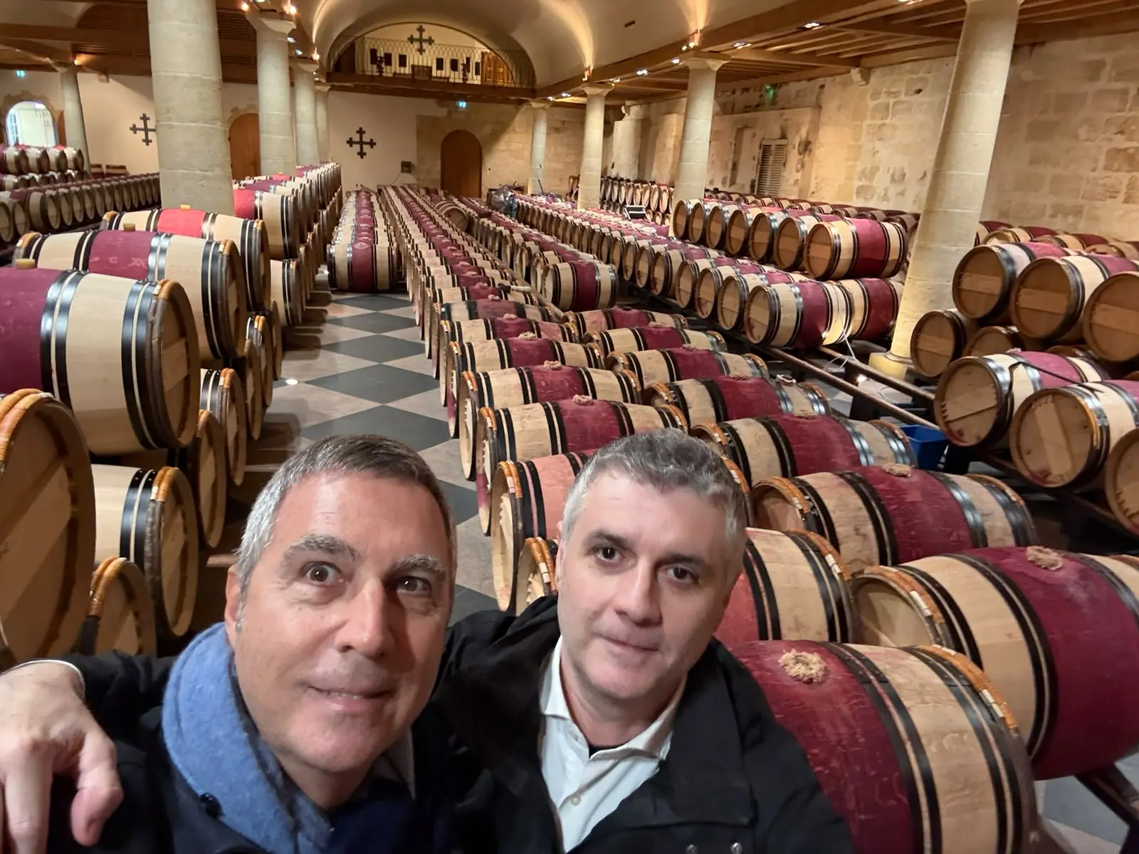 Dante Cerioli and a travelling companion in front of the rows of barrels