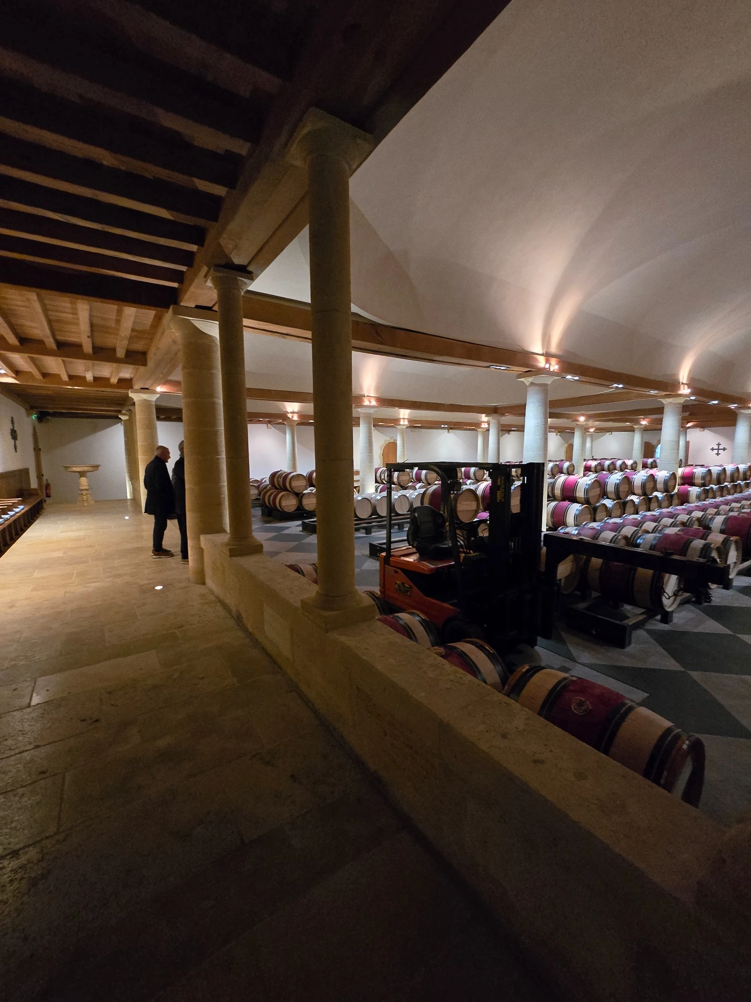 View of the Grand Chai from the walkway, with columns, barrels and a working trolley