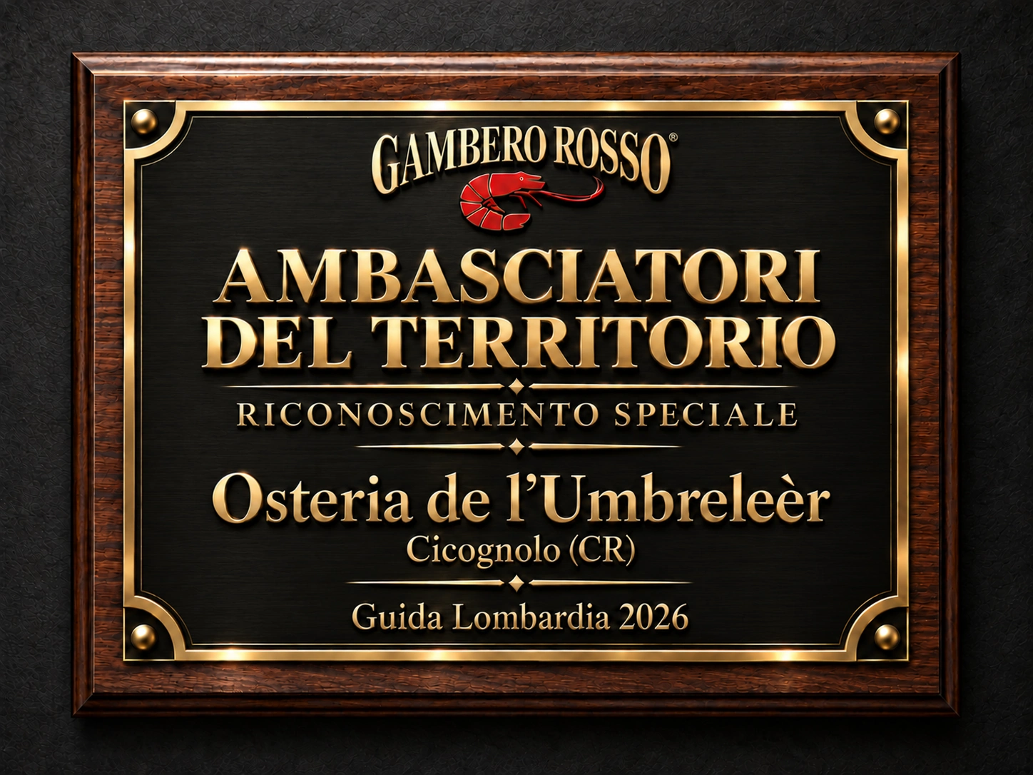 Auszeichnungstafel für die Osteria de l'Umbreleèr, Ambasciatori del Territorio, Gambero Rosso Lombardei-Führer 2026